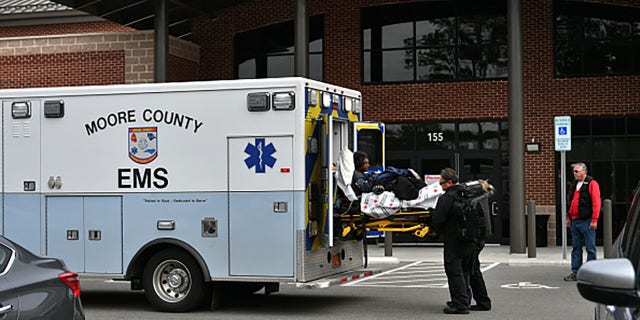 An ambulance is seen in front of a hospital without electricity as tens of thousands are without power in Moore County, North Carolina.