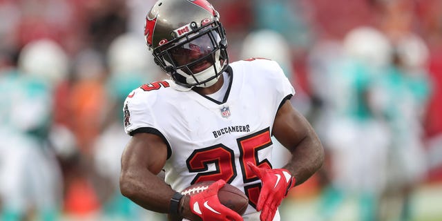 Tampa Bay Buccaneers running back Giovani Bernard (25) warms up before a preseason game against the Miami Dolphins on August 13, 2022 at Raymond James Stadium in Tampa, Florida.