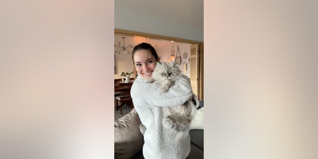 Victoria "Tori" Taillac holds her cat Loki, which she received when she purchased her Utah home in November.