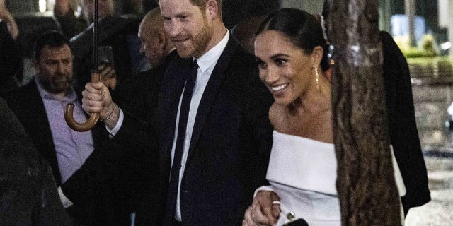 Prince Harry and Meghan Markle held hands as they headed for the Ripple of Hope Awards on a rainy night in New York Tuesday. 