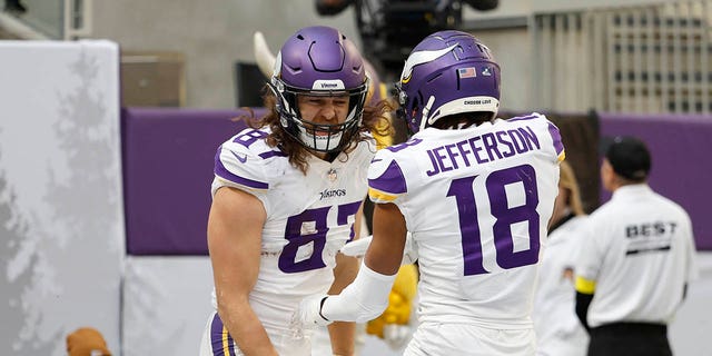 T.J. Hockenson #87 of the Minnesota Vikings celebrates with Justin Jefferson, #18 of the Minnesota Vikings, after Hockenson's receiving touchdown during the first quarter against the New York Giants at U.S. Bank Stadium on December 24, 2022, in Minneapolis, Minnesota.