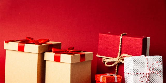 Wrapped Christmas presents in square boxes tied up with ribbon