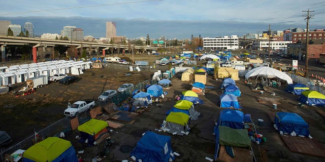Homeless camps are seen in a vacant parking lot in Portland, Oregon, on Dec. 8, 2020.
