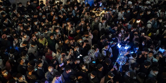 Hong Kong residents gather in front of Victoria Harbour ahead of the countdown on New Year's Eve Saturday Dec. 31, 2022 in Hong Kong.