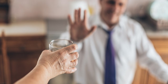 man refuses a drink