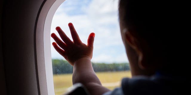 child at airplane window
