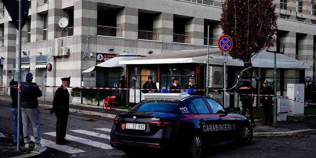 Italian Carabinieri, paramilitary policemen, patrol in front of a bar where three people died after a man entered and shot in Rome, Sunday, Dec. 11, 2022. 