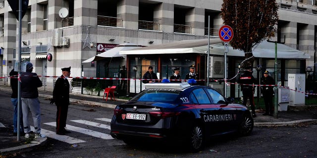 Italian Carabinieri, paramilitary policemen, patrol in front of a bar where three people died after a man entered and shot in Rome, Sunday, Dec. 11, 2022.