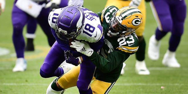 Justin Jefferson of the Minnesota Vikings is tackled by Jaire Alexander of the Green Bay Packers during the second quarter of a game at Lambeau Field in Green Bay, Wisconsin on November 1, 2020.