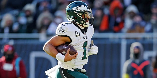 Jalen Hurts, #1 of the Philadelphia Eagles, runs the ball for a touchdown during the second quarter in the game against the Chicago Bears at Soldier Field on December 18, 2022, in Chicago, Illinois. 