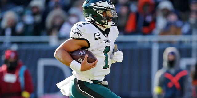 Jalen Hurts, #1 of the Philadelphia Eagles, runs the ball for a touchdown during the second quarter of a game against the Chicago Bears at Soldier Field on December 18, 2022 in Chicago, Illinois.