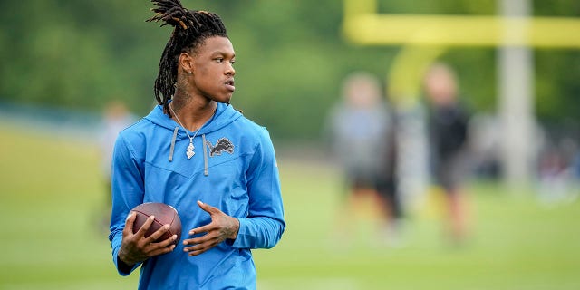 Jameson Williams of the Detroit Lions looks on during training camp July 27, 2022, at the Lions Headquarters and Training Facility in Allen Park, Mich. 