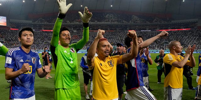 Players of Japan celebrate beating Spain, 2-1, in a World Cup Group E match at Khalifa International Stadium in Doha, Qatar, Dec. 2, 2022.