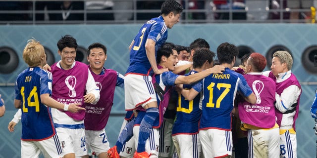 Japan's players celebrate Ritsu Doan's goal against Spain, tying the World Cup Group E match 1-1 at Khalifa International Stadium on December 1, 2022 in Doha, Qatar.