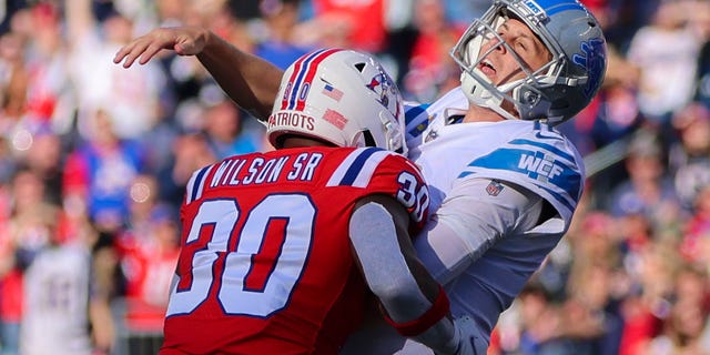 The New England Patriots' Mack Wilson Sr. is called for roughing the passer as he hits the Detroit Lions' Jared Goff.