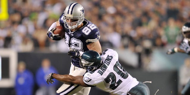 Brian Dawkins #20 of the Philadelphia Eagles tackles Jason Witten, #82 of the Dallas Cowboys, at Lincoln Financial Field on November 4, 2007, in Philadelphia, Pennsylvania.