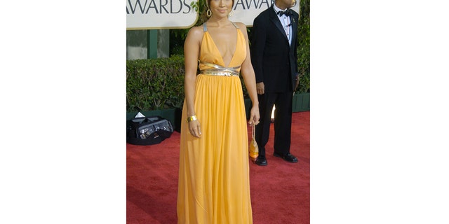 Jennifer Lopez wore a bright orange dress to the Golden Globes in 2004 post split from Ben Affleck.
