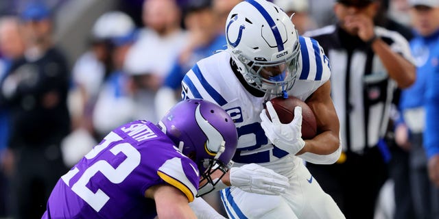 Harrison Smith, #22 of the Minnesota Vikings, tackles Jonathan Taylor, #28 of the Indianapolis Colts, during the first quarter of the game at U.S. Bank Stadium on Dec. 17, 2022 in Minneapolis.