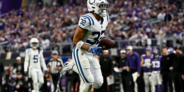 Julian Blackmon of the Indianapolis Colts returns the ball for a pick-six against the Minnesota Vikings during the second quarter of a game at US Bank Stadium on December 17, 2022, in Minneapolis.