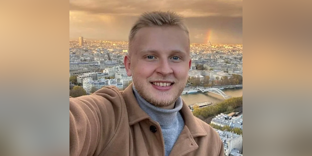 Ken DeLand smiles in selfie shared while studying abroad. 