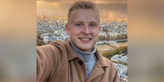 Ken DeLand smiles in selfie shared while studying abroad. 