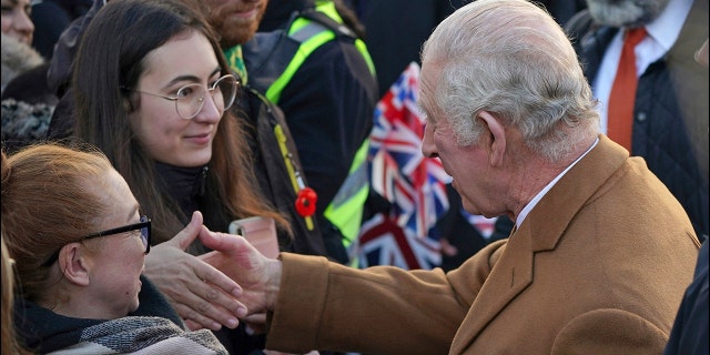 Britain's King Charles III, right, greets members of the public as he arrives for a visit to Luton Town Hall, where he meets community leaders and voluntary organisations, in Luton, England, on Tuesday 6 December 2022. 