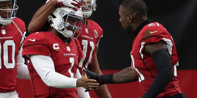 Quarterback Kyler Murray (1) of the Arizona Cardinals is congratulated by DeAndre Hopkins (10), Larry Fitzgerald (11) and Patrick Peterson (21) after scoring a 21-yard rushing touchdown against the Washington Football Team Sept. 20, 2020, in Glendale, Ariz. 