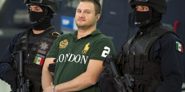 Edgar Valdez Villareal, "La Barbie," center, of the Beltran Leyva drug cartel, is presented to the press at the Federal Police headquarters in Mexico City, on Aug. 31, 2010.