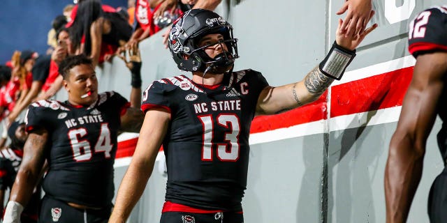 Devin Leary (13) of the North Carolina State Wolfpack celebrates with fans after a game against the Texas Tech Red Raiders Sept. 17, 2022, at Carter-Finley Stadium in Raleigh, N.C.