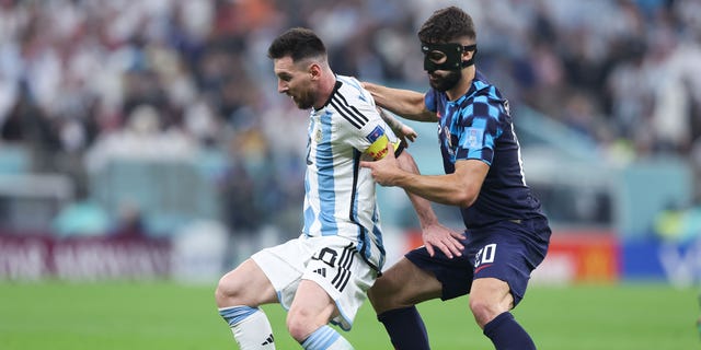 Lionel Messi of Argentina battles for possession with Josko Gvardiol of Croatia at Lusail Stadium on Dec. 13, 2022, in Lusail City, Qatar.