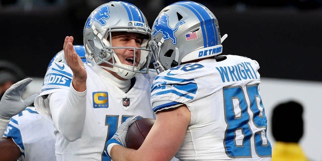 Brock Wright and Jared Goff of the Detroit Lions celebrate a fourth quarter touchdown against the New York Jets at MetLife Stadium on December 18, 2022, in East Rutherford, New Jersey.