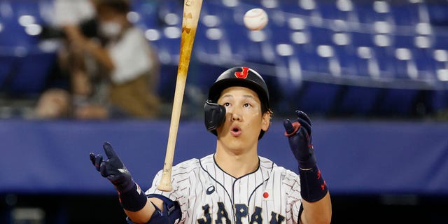 Outfielder Masataka Yoshida #34 of Team Japan reacts while at bat in the sixth inning against Team United States during the gold medal game between Team United States and Team Japan on day fifteen of the Tokyo 2020 Olympic Games at Yokohama Baseball Stadium on August 07, 2021 in Yokohama, Kanagawa, Japan.