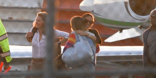 Meghan Markle greets a person awaiting her arrival at the New York City airport Monday.