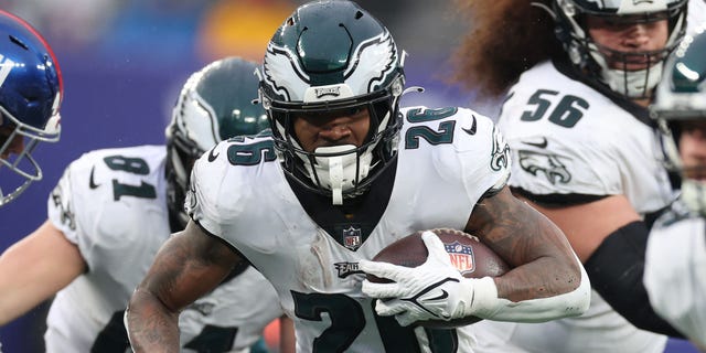 Miles Sanders #26 of the Philadelphia Eagles runs with the ball during the first half of a game against the New York Giants at MetLife Stadium on December 11, 2022 in East Rutherford, New Jersey.