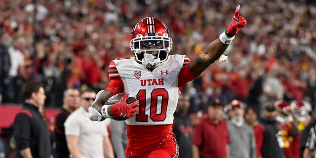 Money Parks #10 of the Utah Utes celebrates as he scores a 57-yard touchdown against the USC Trojans during the third quarter in the Pac-12 Championship at Allegiant Stadium on Dec. 02, 2022 in Las Vegas, Nev. 