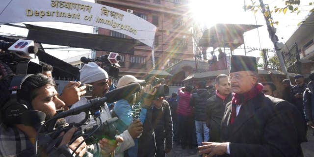 Charles Sobhraj's lawyer Gopal Siwakoti, right, talks to media outside immigration office, in Kathmandu, Nepal, Friday, Dec. 23, 2022. 