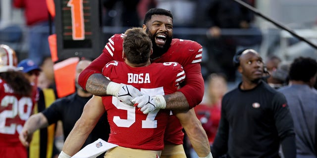 Trent Williams of the San Francisco 49ers hugs Nick Bosa during the fourth quarter against the Miami Dolphins at Levi's Stadium on Dec. 4, 2022, in Santa Clara, California.