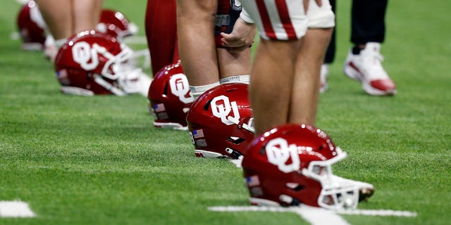 Oklahoma Sooners players line up their helmets while stretching prior to the game against the Oregon Ducks during the Valero Alamo Bowl football game at the Alamodome on December 29, 2021, in San Antonio, TX.