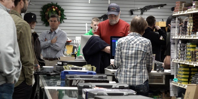 Customers wait in line at Northwest Armory Dec. 6, 2022, in Milwaukie, Oregon.