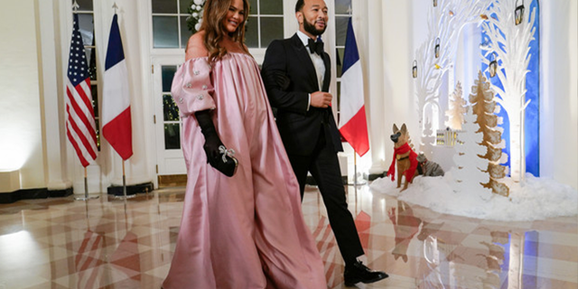 Chrissy Teigen, left, and John Legend arrive for the State Dinner with President Joe Biden and French President Emmanuel Macron at the White House in Washington, Thursday, Dec. 1, 2022. |