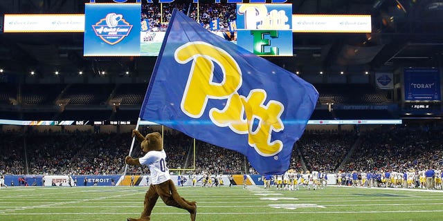 The Pitt mascot runs with the Pitt flag across the field after a score during the Quick Lane Bowl between the Pitt Panthers and the Eastern Michigan Eagles Dec. 26, 2019, at Ford Field in Detroit.  