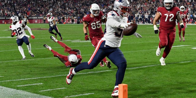 Raekwon McMillan #50 of the New England Patriots recovers a fumble to score a 23 yard touchdown against the Arizona Cardinals during the third quarter of the game at State Farm Stadium on December 12, 2022 in Glendale, Arizona.