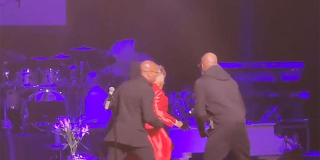 Security rushes Patti LaBelle off stage mid-performance due to a bomb threat at the Riverside Theater in Milwaukee