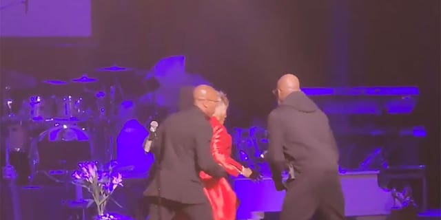 Security rushes Patti LaBelle off stage mid-performance due to a bomb threat at the Riverside Theater in Milwaukee