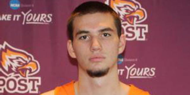 College basketball player Phil Urban poses in team photo.