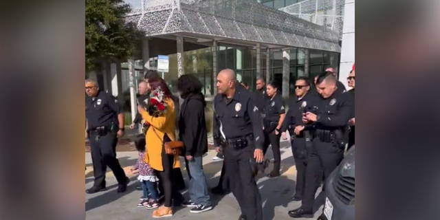 Los Angeles Police Department Capt. E. Morales posted a video on Twitter showing the boy exiting the hospital and walking toward a police cruiser as his family followed carrying balloons.