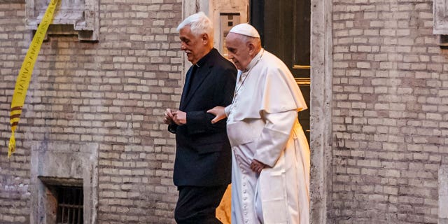 Pope Francis is flanked by Jesuits' superior general Arturo Sosa Abascal, left, after presiding a mass on March 12, 2022.