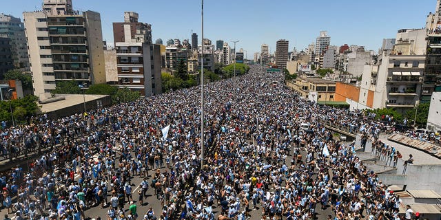 Argentinians crowd a highway for a homecoming parade for the nation’s soccer team that won the World Cup tournament in Buenos Aires on Dec. 20, 2022.