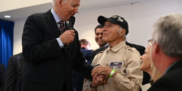 President Biden speaks with Ray Firmani, a 101-year-old World War II veteran, during a town hall with veterans and veteran survivors in New Castle, Delaware, on Friday.
