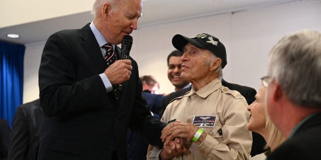 President Biden speaks with Ray Firmani, a 101-year-old World War II veteran, during a town hall with veterans and veteran survivors in New Castle, Delaware, on Friday.